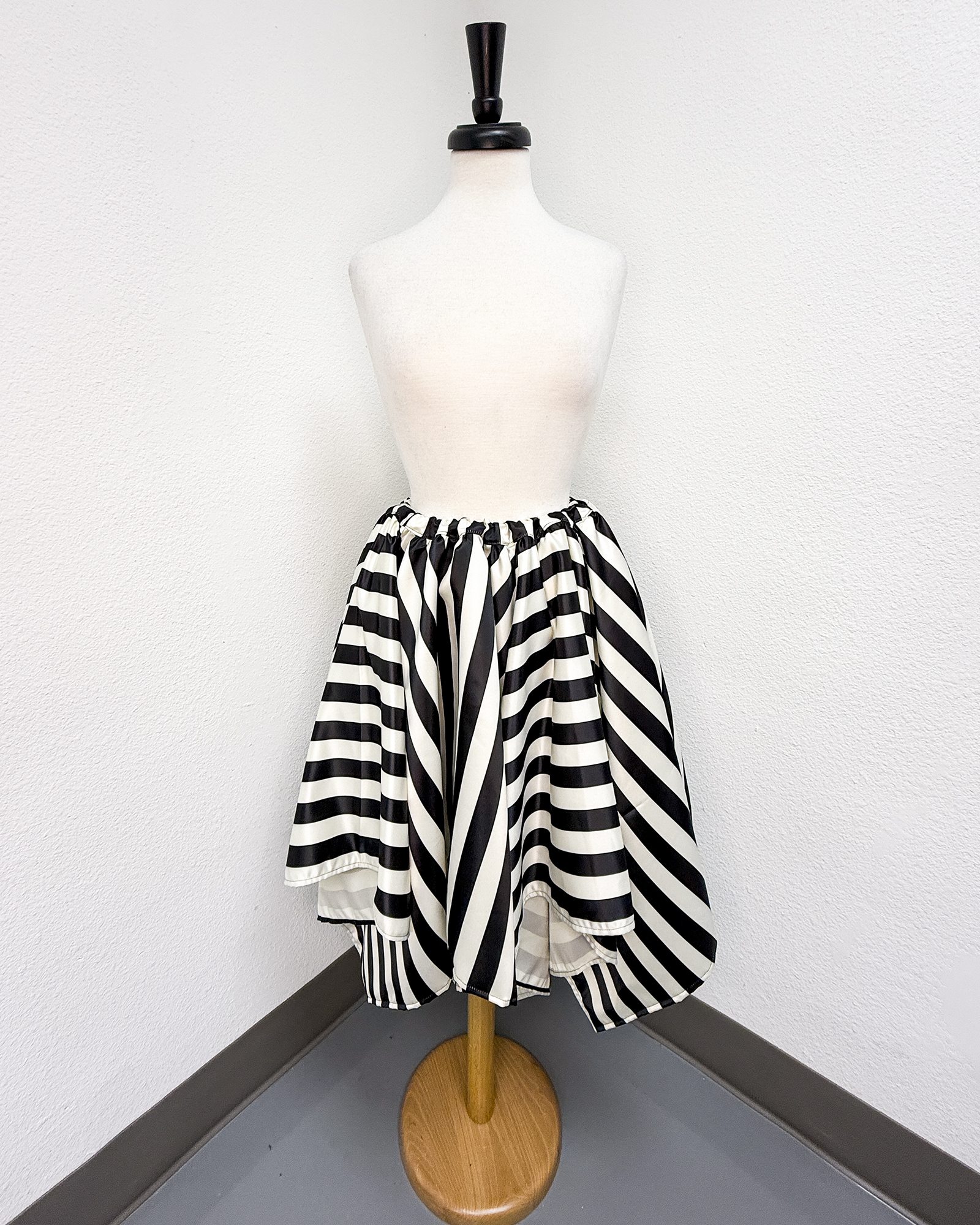 Ivory and Black Striped Satin Petal Skirt displayed on a mannequin