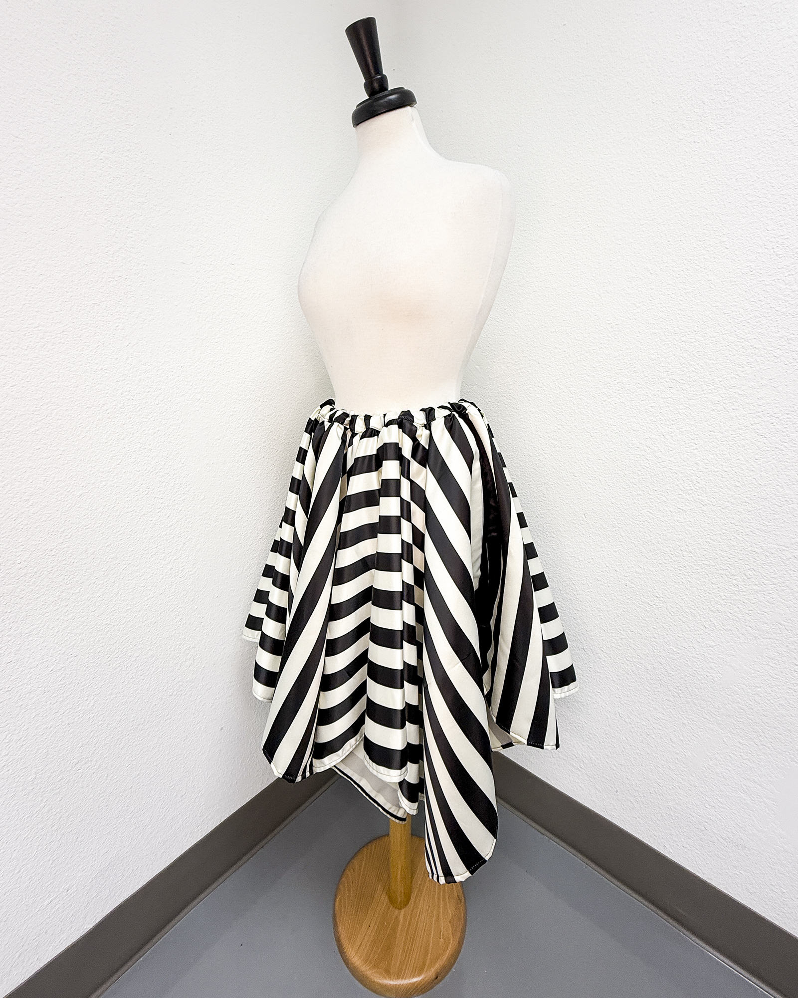Ivory and Black Striped Satin Petal Skirt displayed on a mannequin