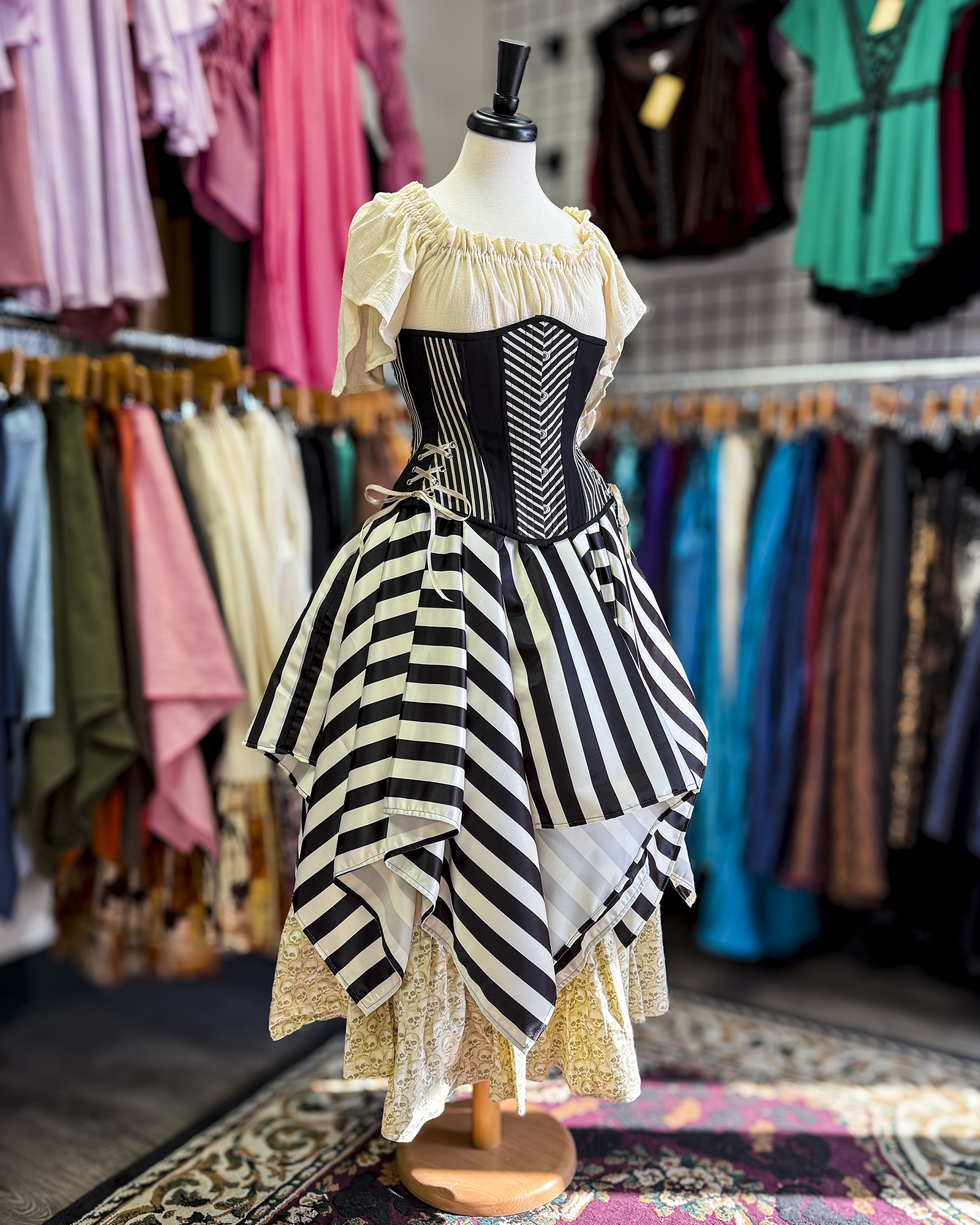Ivory and Black Striped Satin Petal Skirt displayed as part of a four piece outfit on a mannequin